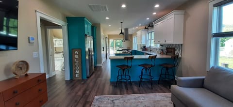 Open concept living room, kitchen and dining area.