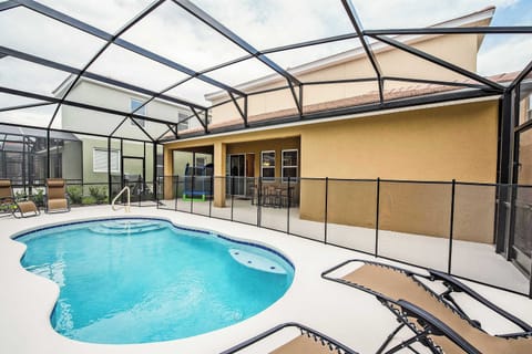 Relax by your private pool with a safety fence, lounge chairs, and a covered patio perfect for family fun and relaxation.