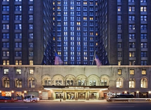 Arrive in style beneath glowing lights at the grand entrance