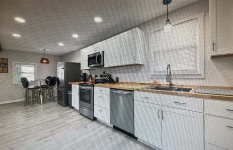 Kitchen with coffee pot, pans, dishes, etc