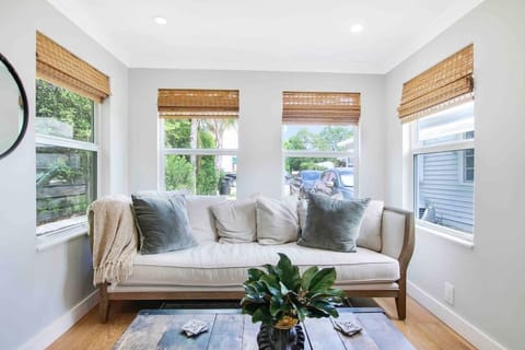 Relax on this comfy couch in the sunroom.