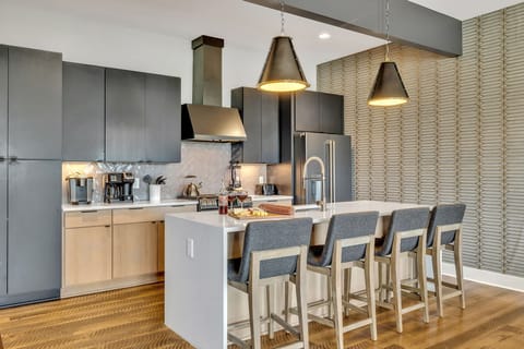 Modern sleek kitchen stocked with your basic cooking essentials. Complete with stainless steel appliances and breakfast bar seating.