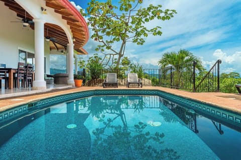 A spacious poolside lounge area, perfect for relaxing and enjoying the sun.