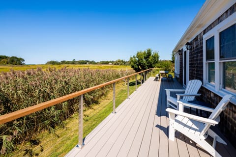 Beautiful sunny deck with lounge chairs and dining table