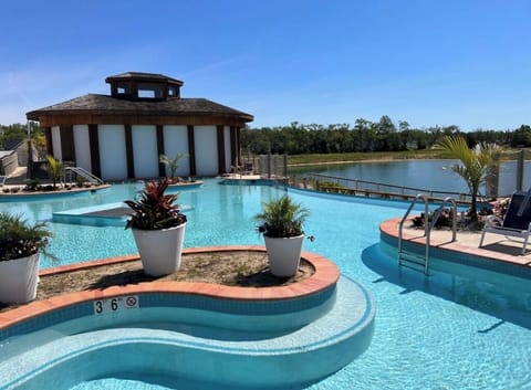 Crystal clear infinity pool with swim up bar.