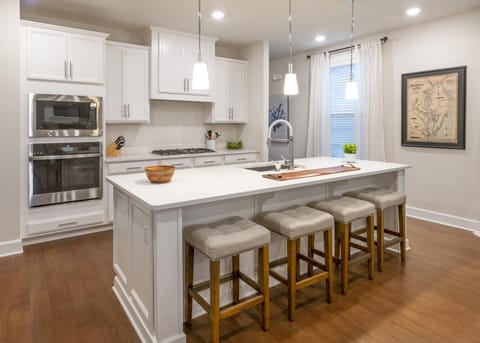 A large quartz counter has ample seating for 4.