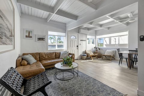 Bright open living space w/ vaulted white-beam ceilings & cozy seating for relaxed gatherings.