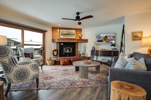 Curl up in your cozy living room where rustic charm meets modern comfort, complete with fireplace and mountain views.