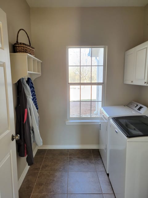 Our laundry room has a new washer and dryer, with detergent available if needed.