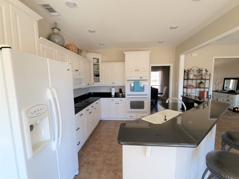 A view of the kitchen from the breakfast nook. 