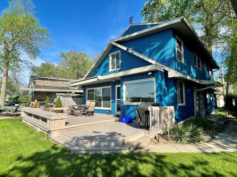 Back deck with patio furniture and 4-burner propane grill