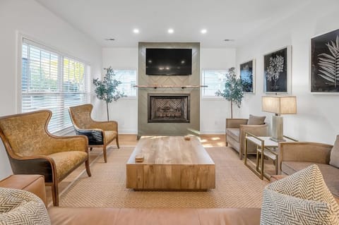 Cozy family room featuring a warm gas fireplace, plush seating, and a relaxing ambiance. Perfect for movie nights, game time, or simply unwinding with loved ones after a fun-filled day.