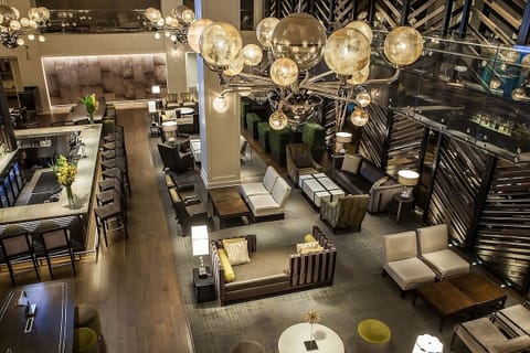 Unwind beneath statement lighting in an elegant lounge retreat.