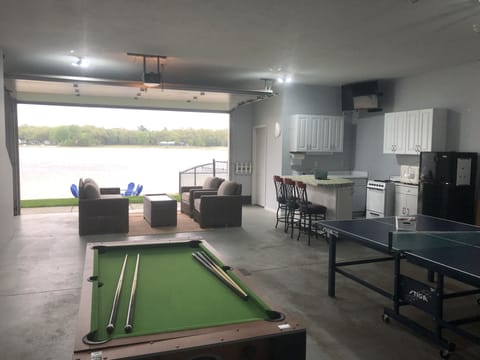 Rec room with game table, ping pong, tv and bar. A fun family space.