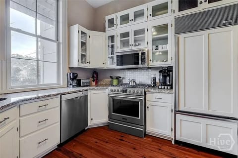 Large gas range and Sub-Zero fridge