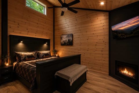 Bedroom 1 features a cozy king bed with rustic cabin charm.