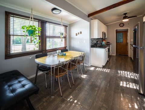 Our dining room table has six chairs and a bench, with room for 8.