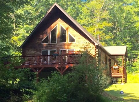 View as you drive in toward the chalet showing deck, living room and loft