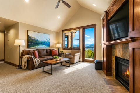 Bright living room with private balcony & fireplace