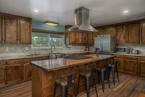 Large open kitchen well stocked with cooking essentials.