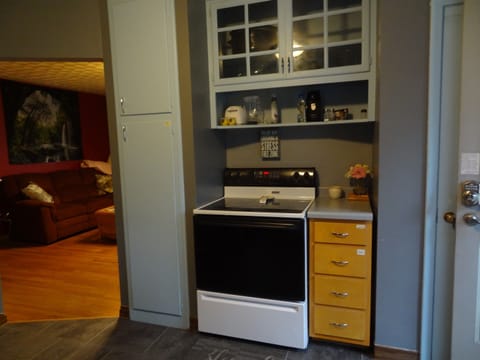 Kitchen with full stove and refrigerator