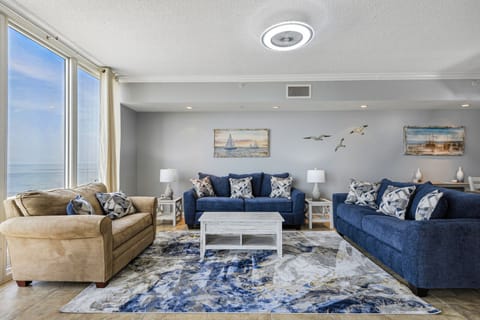 Living room. Tan love seat is a sleeper. Big screen tv not pictured.
