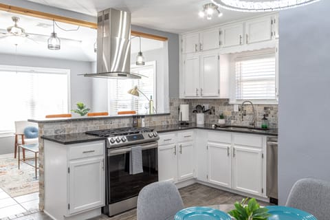 Full size kitchen featuring coffee machine, microwave, oven, & dishwasher