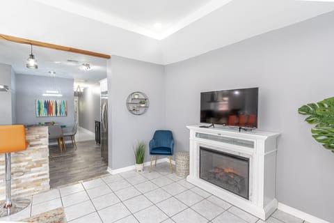 Smart Roku TV with apps like Netflix, Hulu, Disney +, and electric fireplace