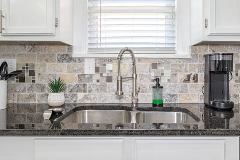 Full, double sided kitchen sink featuring our coffee maker