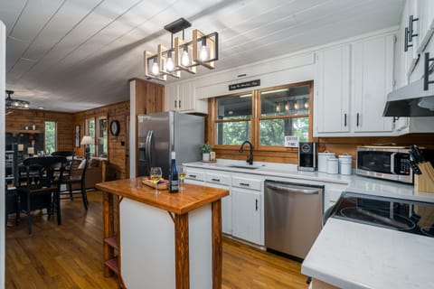 Kitchen is well stocked with extra dishes, utensils, cookware and appliances. 