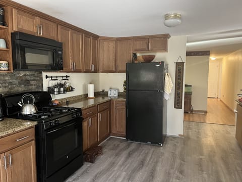Country kitchen with granite countertops and fully applianced