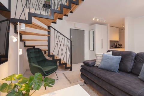 Air-conditioned living room with a sofa bed, coffee table and TV.