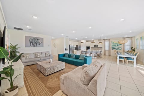 - Open concept living area with bright natural light  
- Large sectional seating flows into kitchen and dining  
- Spacious setup perfect for group gatherings and meals