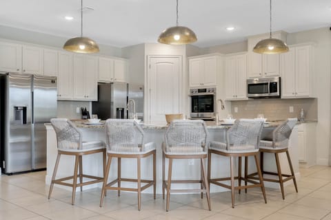 - Gourmet kitchen with sleek double refrigerators  
- Granite island bar with seating for casual dining  
- Modern appliances ready for group meal preparation
