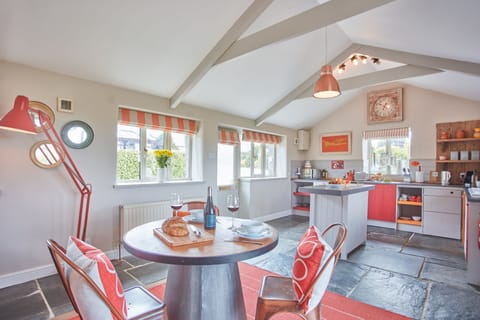 Meadow View, Newquay. Well-equipped kitchen and dining area with bespoke slate flooring, electric oven and hob, integrated fridge/freezer, dishwasher, washer/dryer and a dining table for two guests