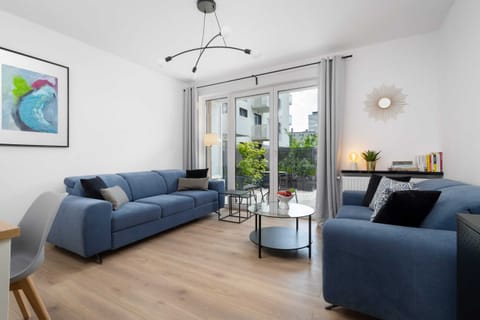 Relax in the stylish living room with comfortable sofas and modern decor.