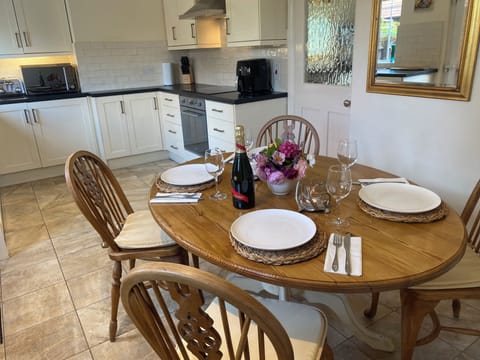 Enjoy dining at the traditional farmhouse table and chairs.