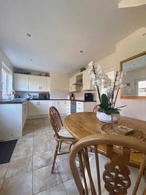 Fully equipped kitchen including air fryer, coffee maker & dining area for six.