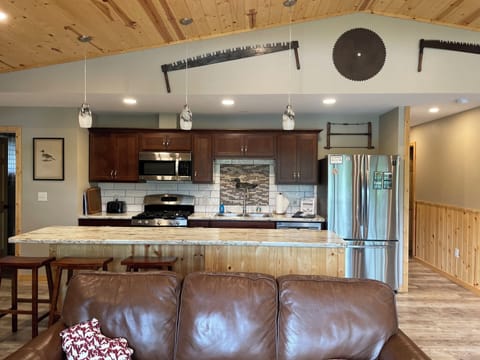 Fully stocked kitchen with dishwasher, microwave, gas stove and 10 foot island