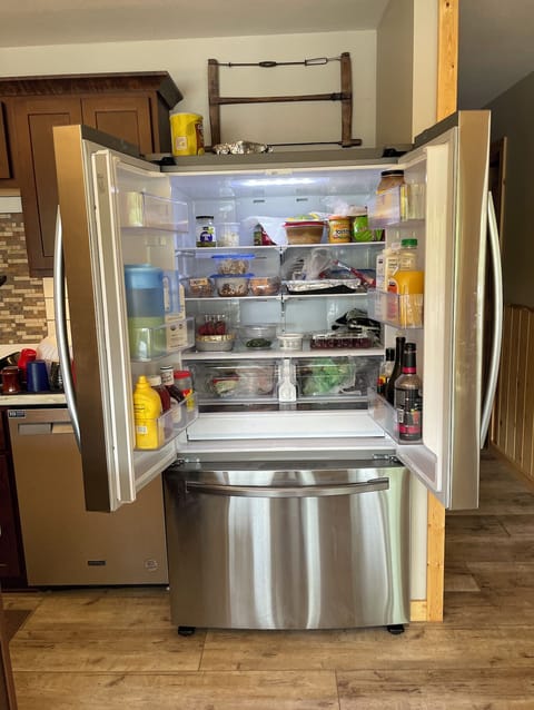 Full sized refrigerator in kitchen