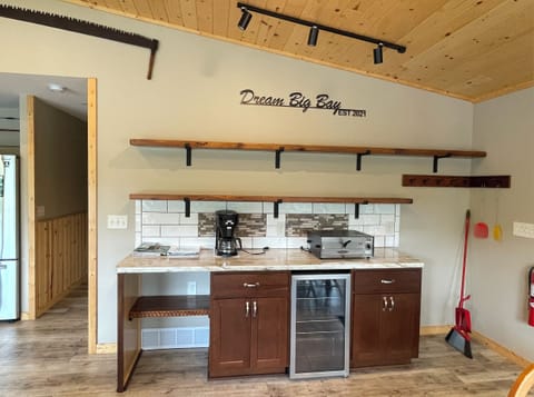 Shelving units and cupboard space for storage; BUNN coffee maker and pizza maker