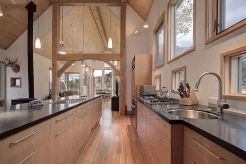 Unleash your inner chef in this dream kitchen - huge island, two sinks, two fridges, large gas range with hideaway vent, high end appliances and mountain views!