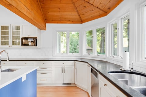 Bay windows in the kitchen flood the space with natural light