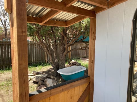 A peak through the gazebo. There is a deer behind the bathtub