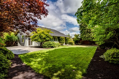 Huge, private backyard with mature landscaping. Outdoor table and chairs.