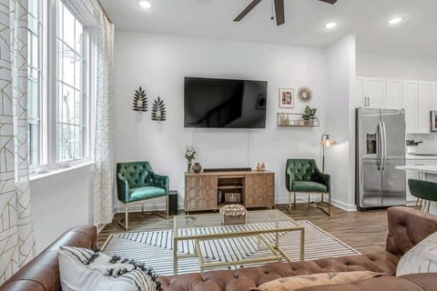 Roomy living area with a mounted Smart TV and comfortable seating for everyone.