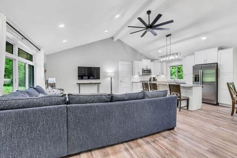 Plenty of seating on the sectional in the gathering area, large TV