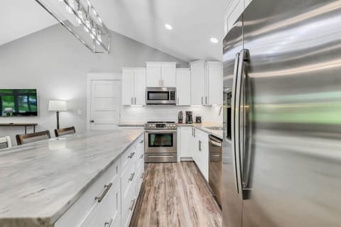 Stocked kitchen with drip coffee pot, small crock pot, mixer