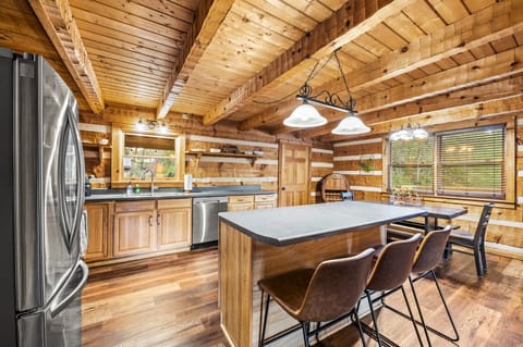 Large kitchen is fully stocked with cookware and dinnerware.