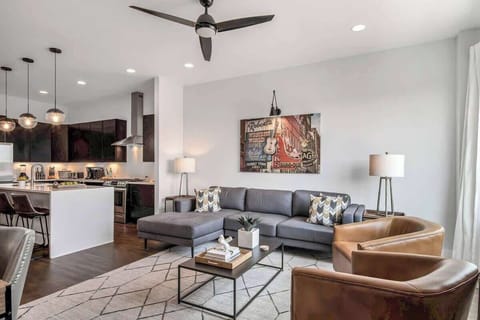 Comfortable living room with a gray L-shaped couch and two inviting brown chairs